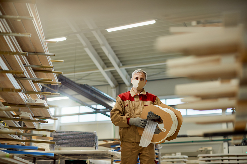 view-carpenter-carrying-protective-foam-while-working-workshop-1